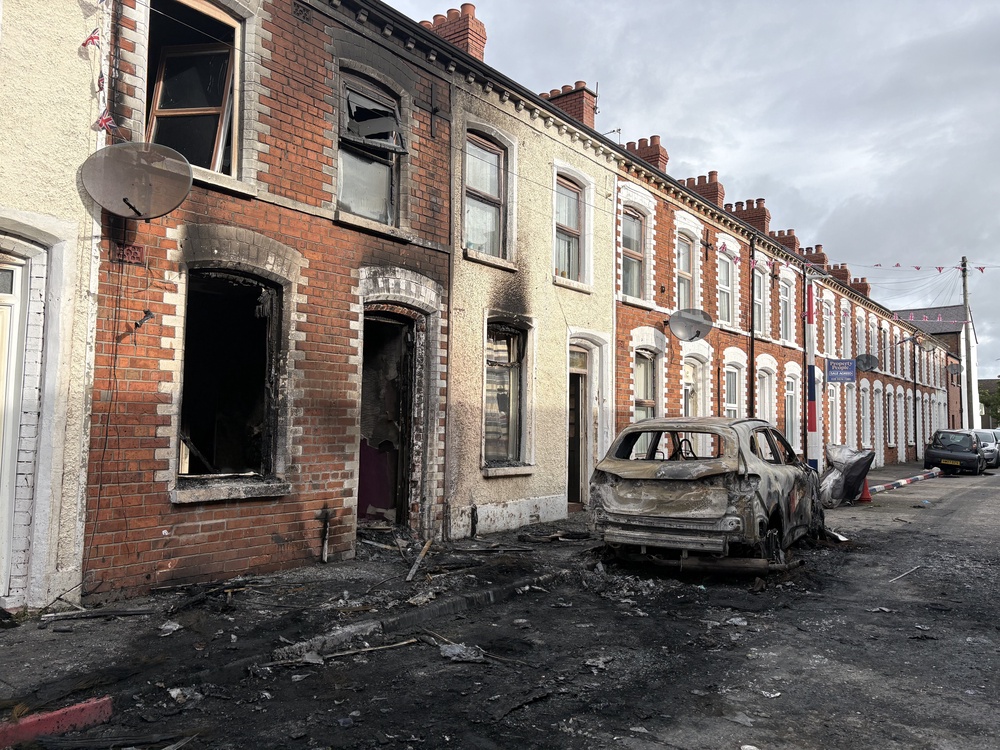 Burned-out cars and houses on Lendrick Street after Tuesday night’s disorder (PA) (PA Wire)