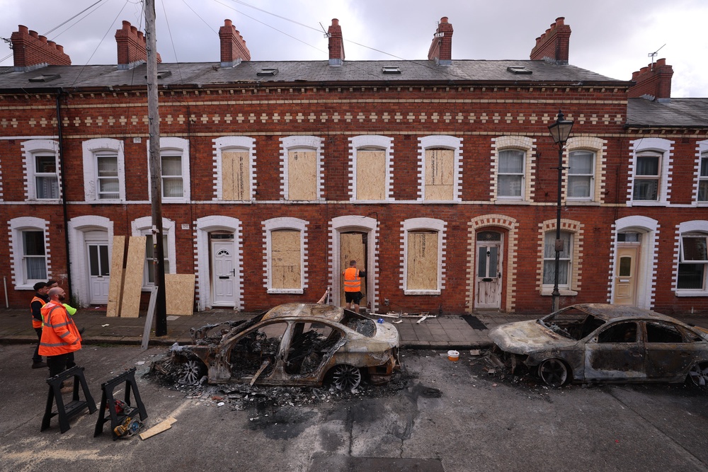 Burned out cars and boarded up houses on McMaster Street in east Belfast (Liam McBurney/PA) (PA Wire)