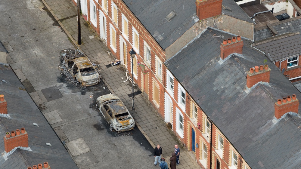 Drone view shows burnt vehicles in the aftermath of anti-immigrant protests in Belfast (Reuters)