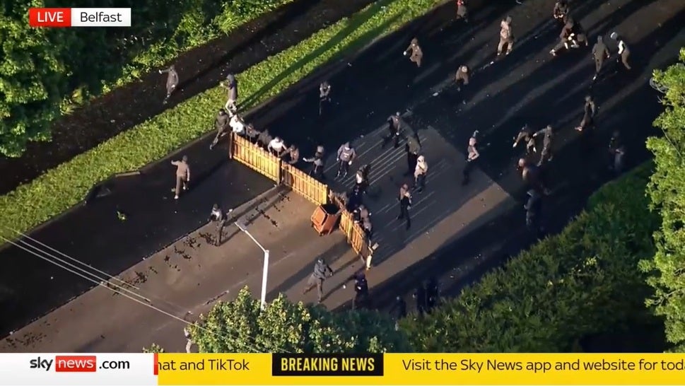 Youths used fencing to protect themselves from the water cannon (Sky News)