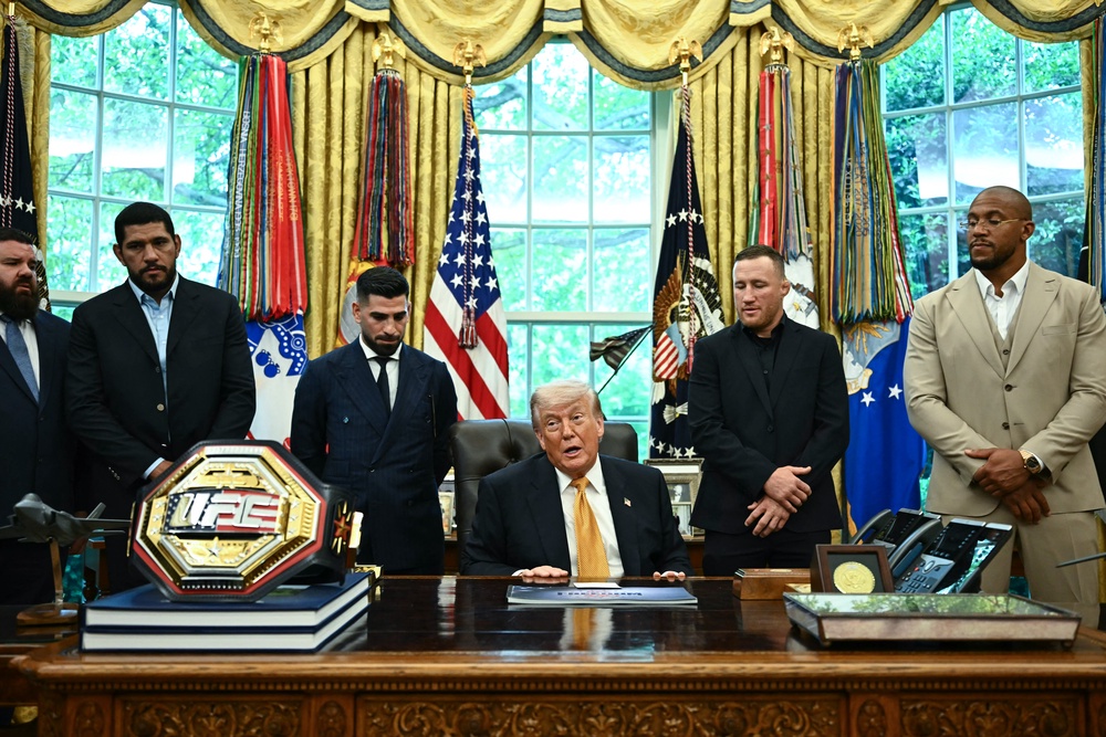 President Donald Trump, alongside (L/R) US mixed martial artist coach Plinio Cruz, Brazilian mixed martial artist Alex Pereira, Georgian-Spanish mixed martial artist Ilia Topuria, US mixed martial artist Justin Gaethje, and French mixed martial artist Ciryl Gane, speaks about the upcoming 