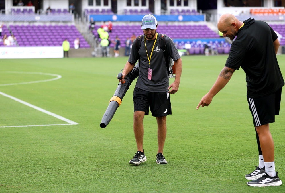 A member of ground staff dries the pitch following heavy rain prior to the International Friendly match between England and Costa Rica (Getty)