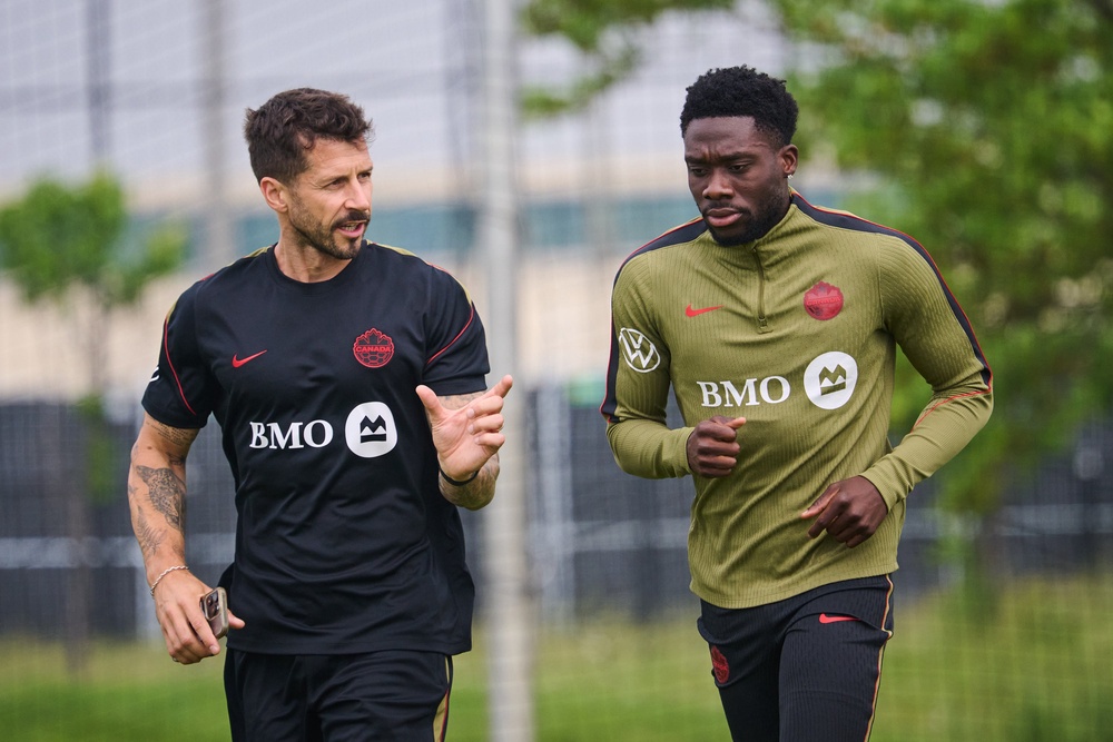 Canada's Alphonso Davies, right, runs laps during a World Cup soccer training session in Toronto (AP)