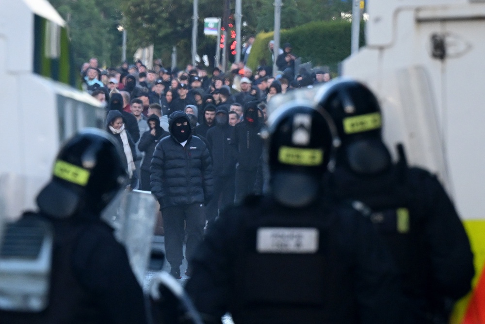 Police stand guard as protests take place near the Chimney Corner Hotel, which may be a hotel housing migrants (Getty)
