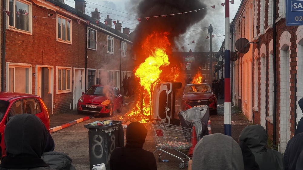 Vehicles set on fire by protesters on Lendrick Street in Belfast (PA) (PA Wire)