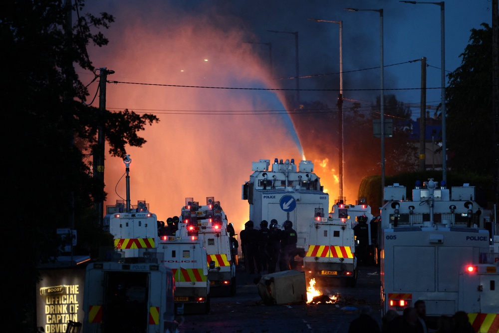 Police use a water cannon as they block the road from protesters (AFP/Getty)