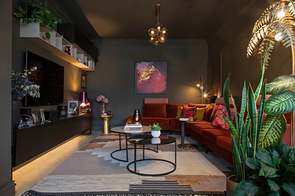 A deep colour palette, rich timber and layered lighting give this games room a cocooning feel, showing how darker tones can bring warmth, character and atmosphere to a space (Carol Crowe Interior Design/PA)