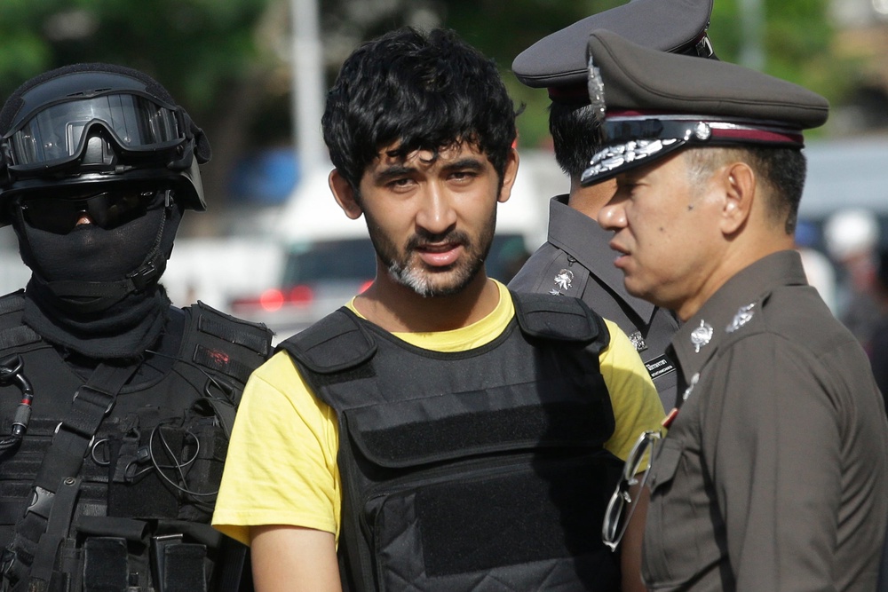 File: Police officers escort Yusufu Mieraili, yellow shirt, outside Hua Lamphong railway station in Bangkok, on Sept. 9, 2015 (Copyright 2026 The Associated Press. All rights reserved.)