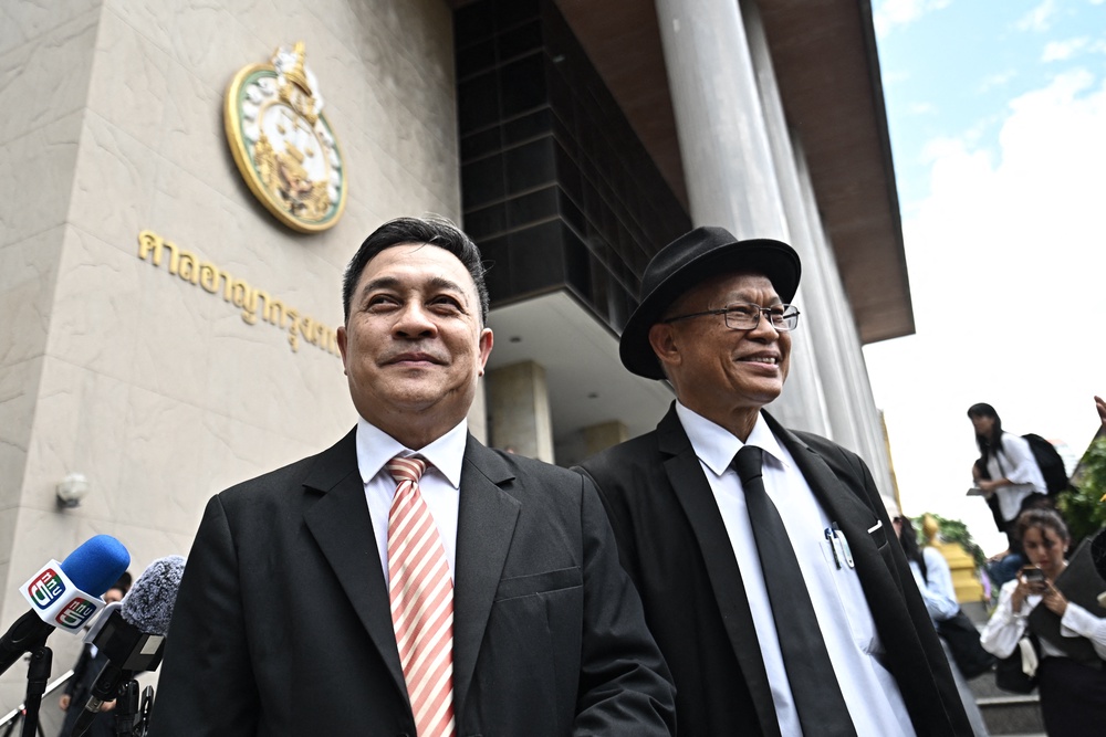 Lawyer Choochat Kanpai (L), representing bombing suspects Bilal Mohammed and Yusufu Mieraili, stands outside the Bangkok South Criminal Court in Bangkok on June 11, 2026, after the verdict for the Erawan Shrine bombing on August 17, 2015 (AFP/Getty)