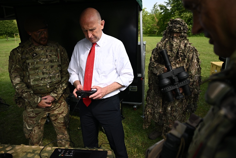 John Healey uses a controller to try an FPV drone training system in 2025 (Getty)