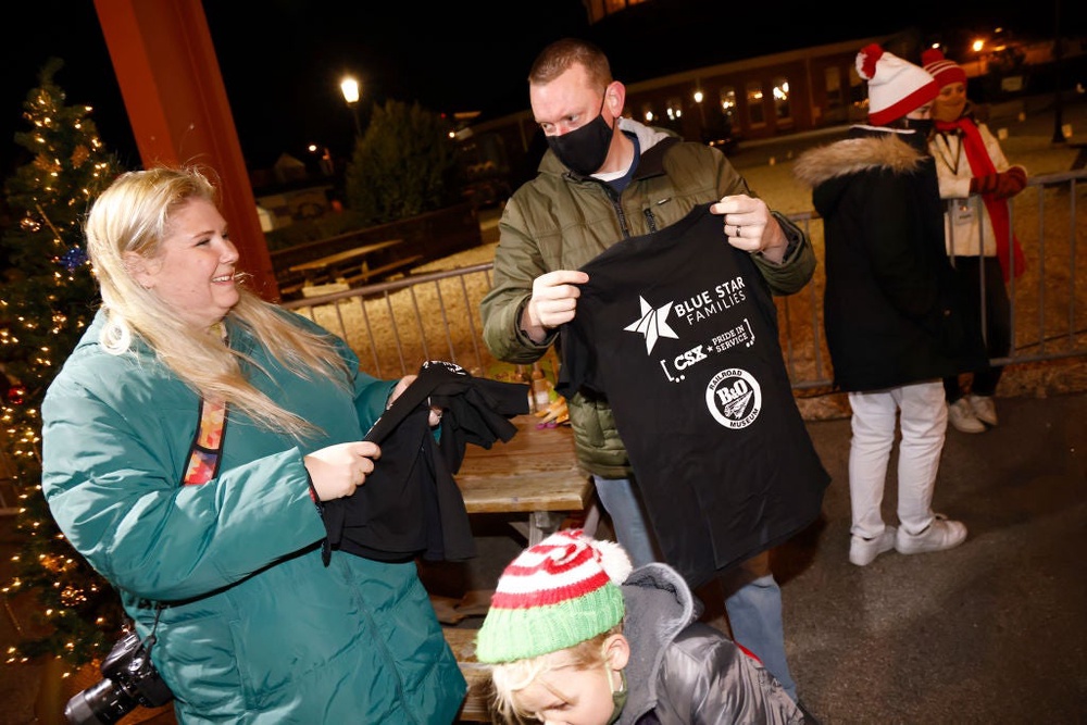 Young guests receive their gifts at a 2021 Christmas event in Baltimore, Maryland, sponsored by the History Channel and Blue Star Families. Blue Star is one of several charities that Craigslist founder Craig Newmark, whose father served in the military, donates to (Getty Images for History Channel)
