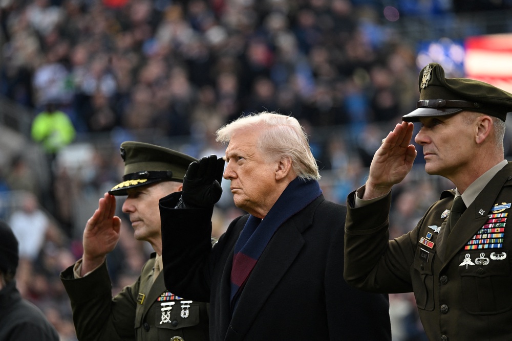 Donald Trump salutes  before the college football game between the US Army and Navy at the M&T Bank Stadium in Baltimore last December (AFP/Getty)