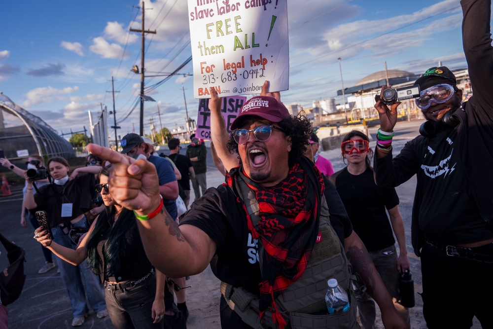 A demonstrator shouts at ICE agents and another holds a sign referencing ‘slave labor camps’ while protesting outside the Delaney Hall Immigration Detention Center in Newark, New Jersey, on June 7, 2026. (Getty)