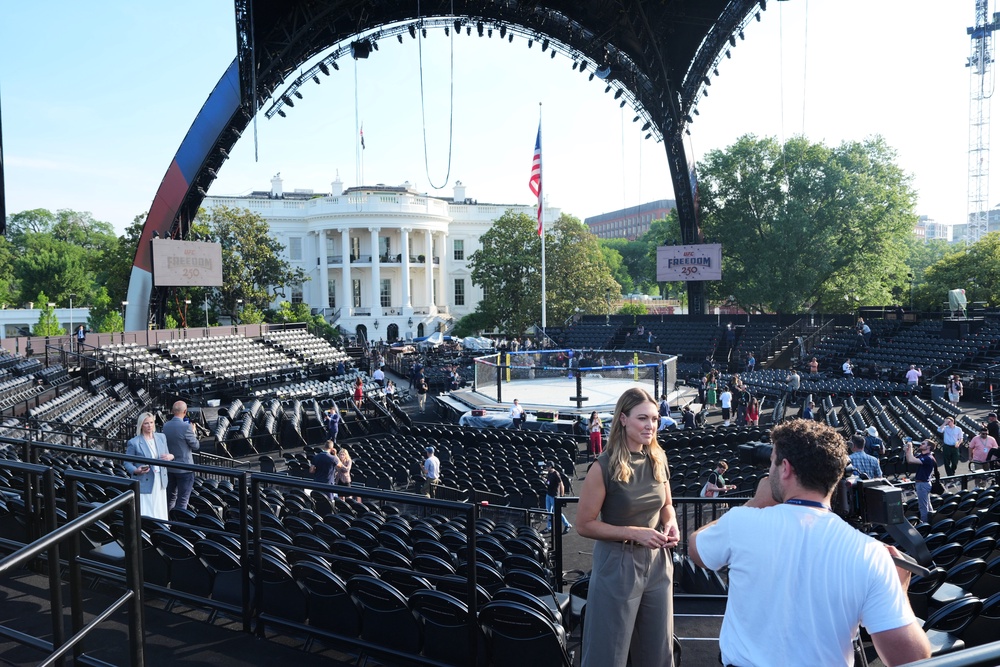 The arena for the fight doesn’t fully protect audience members and fighters from the elements (AP)