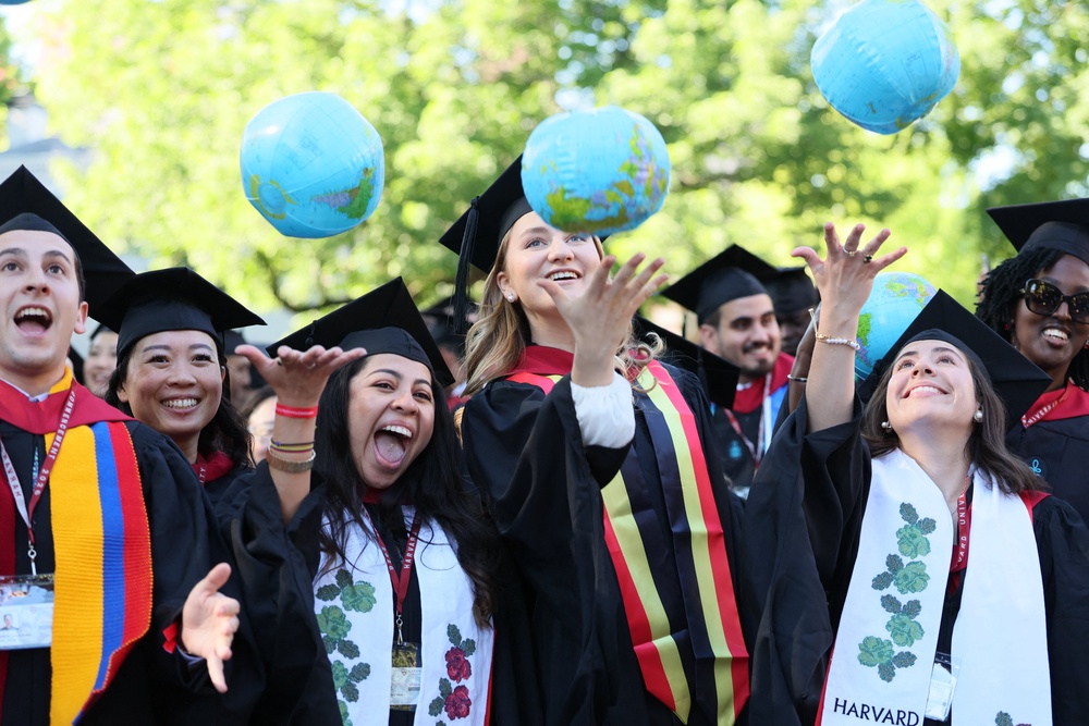 Tuition fees 'started taking off' in the 1980s alongside the growth of federal student loan programs, one expert said. Pictured here, Harvard University students take part in graduation celebrations in May (BELGA MAG/AFP via Getty Images)