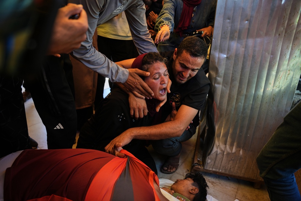 Abeer Abu Younis mourns over the body of her son, Mustafa Abu Younis, 14, who was killed in an Israeli airstrike in Khan Younis, southern Gaza Strip (Copyright 2026 The Associated Press. All rights reserved.)