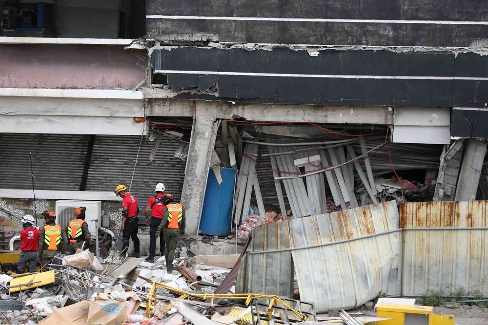 Rescue workers search a building damaged by the earthquake in General Santos city, Philippines, on 10 June  2026 (AP)