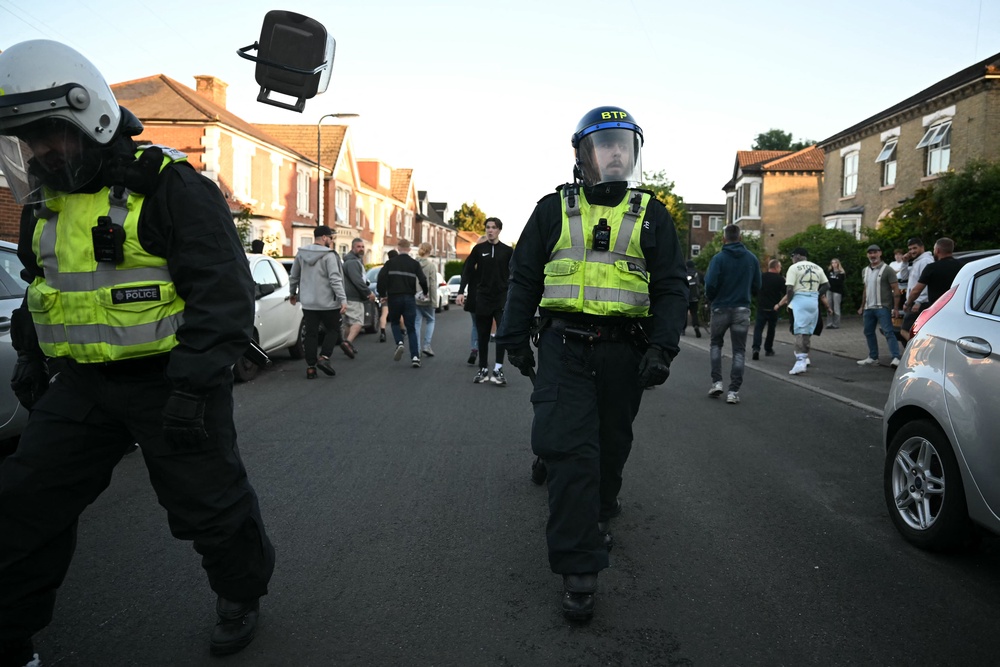 Demonstrators throw objects at Police officers near Portswood Police station, following a protest march in Southampton (AFP/Getty)