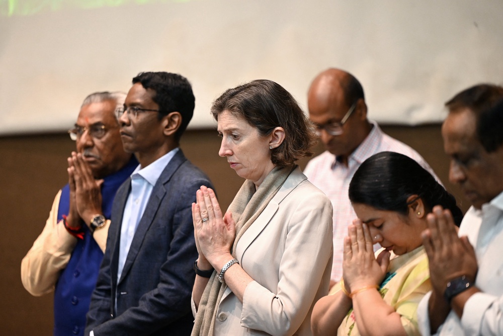 British high commissioner to India Lindy Cameron gestures during a prayer meeting in memory of the Air India crash victims in Ahmedabad on 12 June 2026 (AFP/Getty)