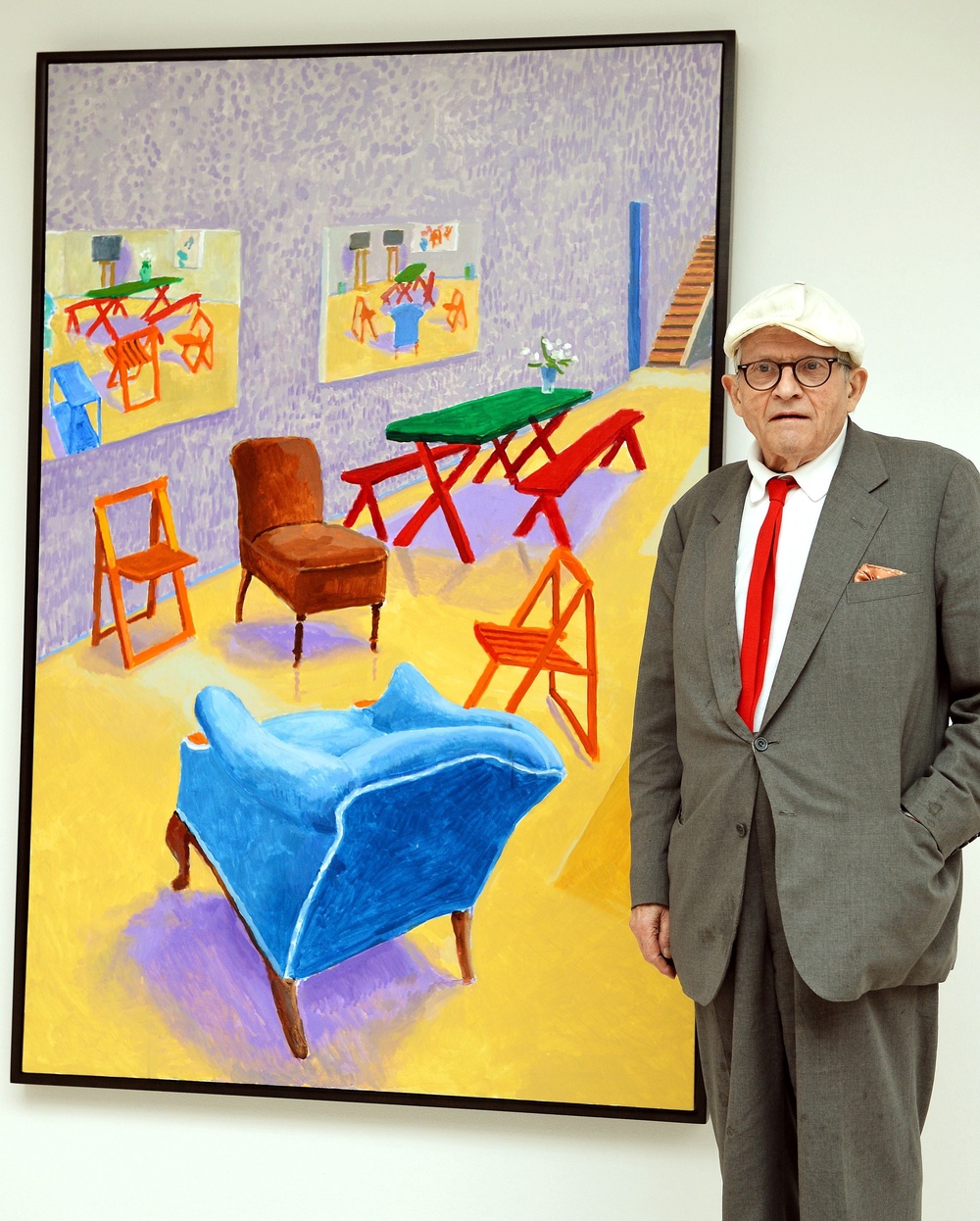 David Hockney standing with his work, “Studio Interior #2” in 2015 (PA)