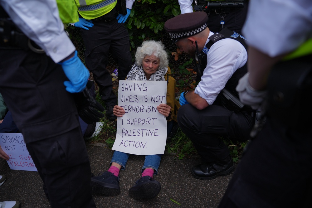 Many protesters held signs that said 'saving lives is not terrorism' (PA)