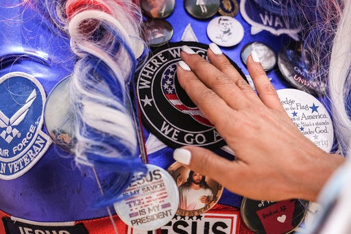 President Trump has repeatedly indulged the QAnon conspiracy theory, whose followers believe the Republican will take on a shadowy group of global elites (AP)