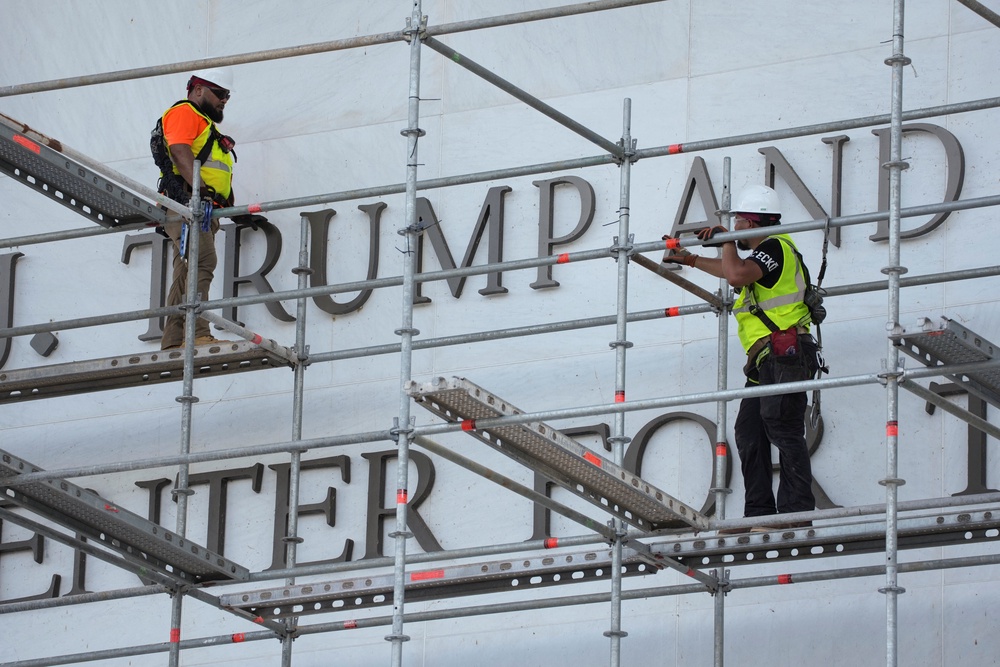 Construction workers erected scaffolding outside the Kennedy Center on June 12 to begin removing Trump’s name after the administration lost another legal fight over his attempts to rename the performing arts venue after himself (Reuters)