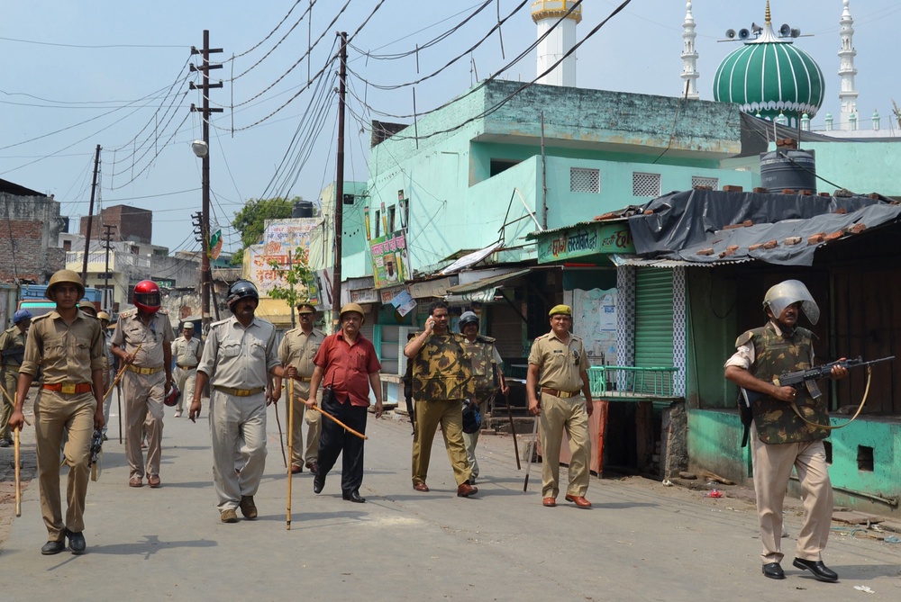 Security personnel patrol during a curfew in Muzaffarnagar on 10 September 2013 (AFP/Getty)