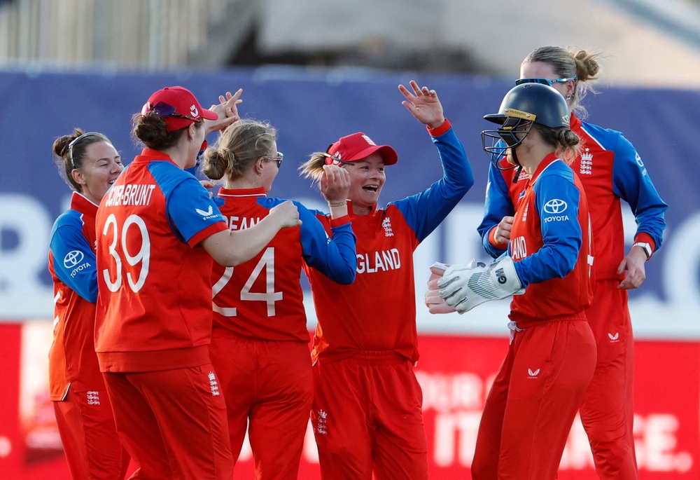 England's Danni Wyatt-Hodge celebrates with teammates after taking a catch to dismiss Chamari Athapaththu off the bowling of Charlie Dean (Reuters)