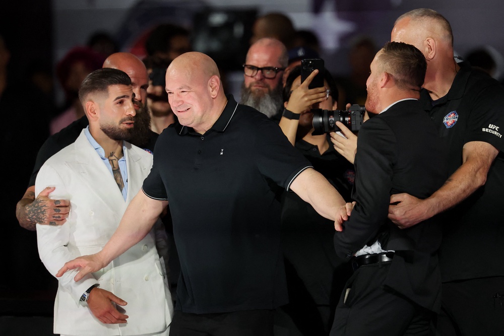 Justin Gaethje (right) and Ilia Topuria being held back from one another (Reuters)