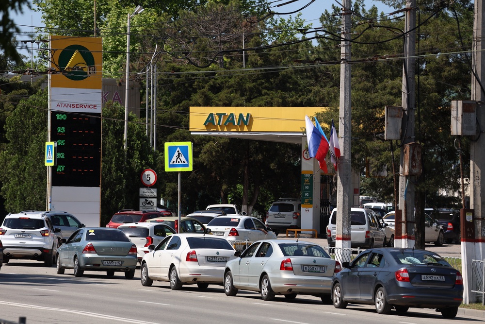 Cars line up at a petrol station in Simferopol, Crimea amid fuel shortages caused by Ukraine’s drone campaign (AP)