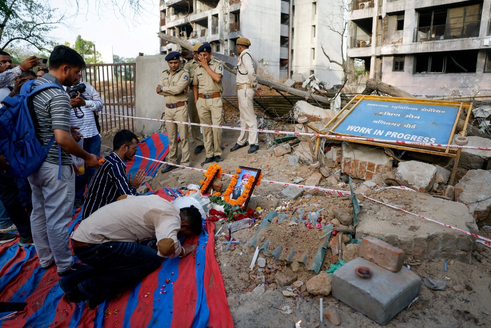 A family member prays at the crash site during the first anniversary of the Air India Boeing 787-8 Dreamliner crash in Ahmedabad, India (Reuters)