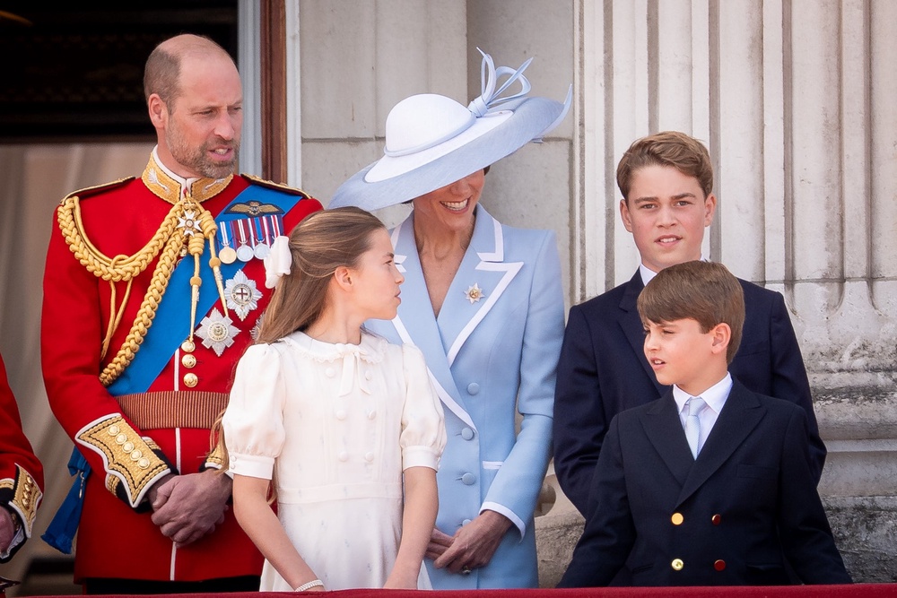 Kate smiles as the family gather on the balcony (PA)