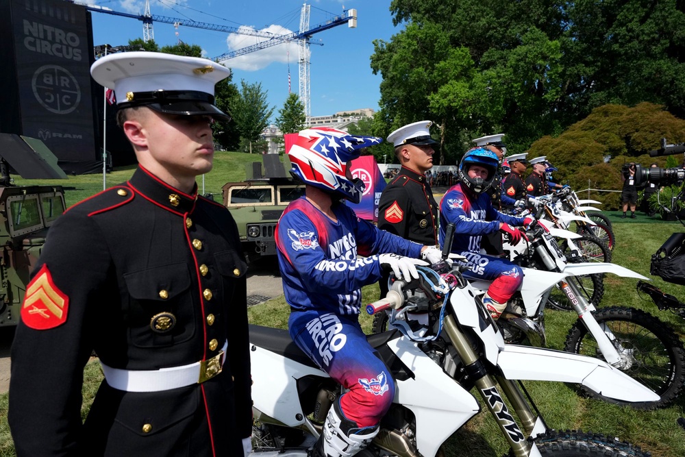 Motorsports athletes and stunt performers line up alongside members of the military after doing a motorcycle jump ahead of the UFC Freedom 250 fights on the South Lawn of the White House (Getty Images)