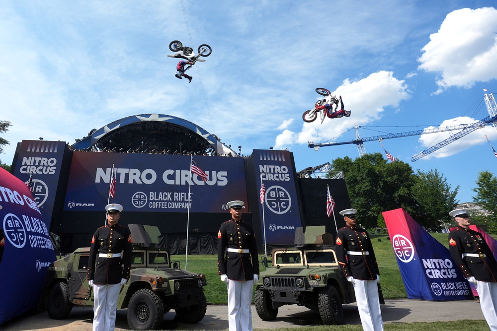 Athletes are seen soaring through the air while US service members stand at attention in the foreground (Getty Images)