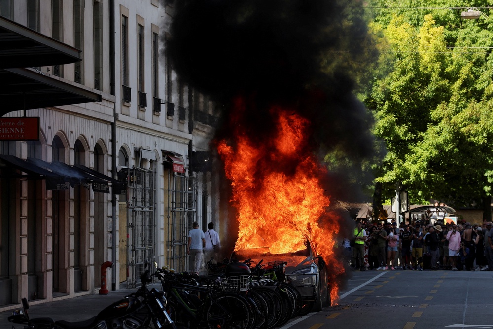 A Tesla car burns during a protest against the upcoming G7 summit in Evian-les-Bains in France (Reuters)