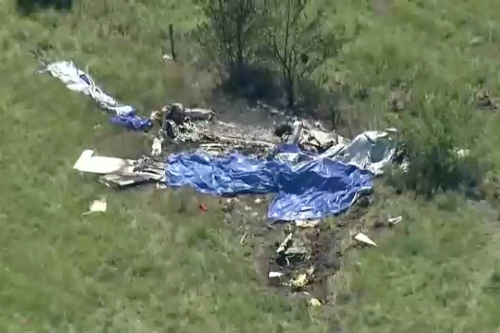 Wreckage lies in a field next to Butler Memorial Airport after a plane carrying skydivers crashed in Butler, Missouri (Reuters)