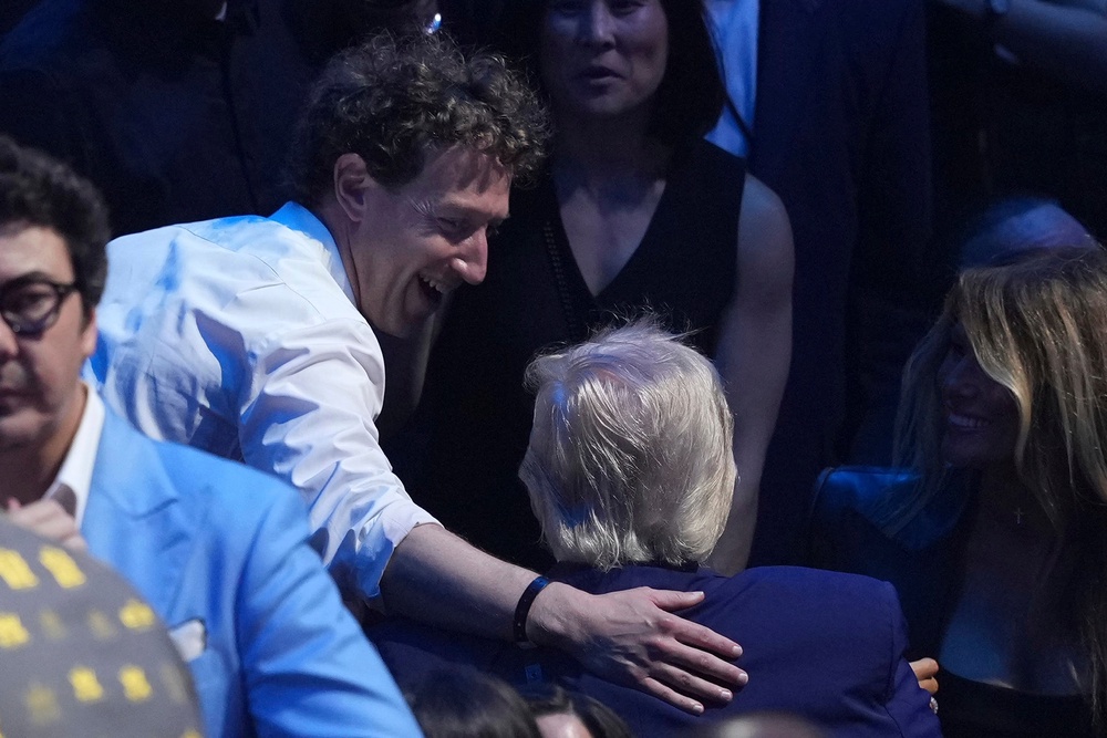 Meta chief executive Mark Zuckerberg was seen patting the president on the back as they greeted each other ringside (AP)