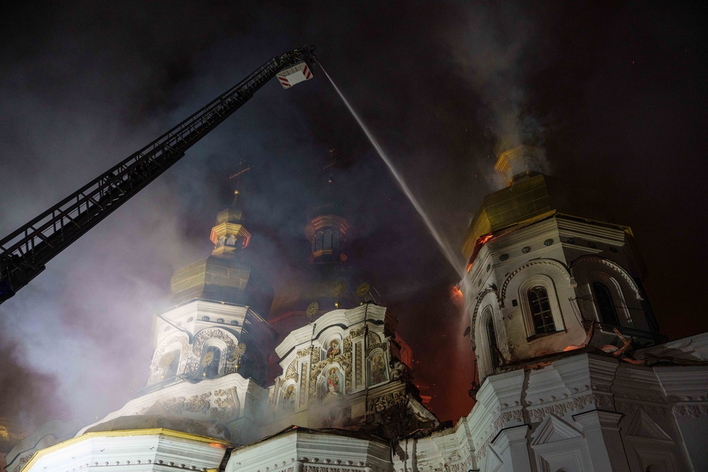 Rescue workers put out a fire of the Dormition Cathedral of the Kyiv-Pechersk Lavra during a Russian strike on Kyiv (AP)