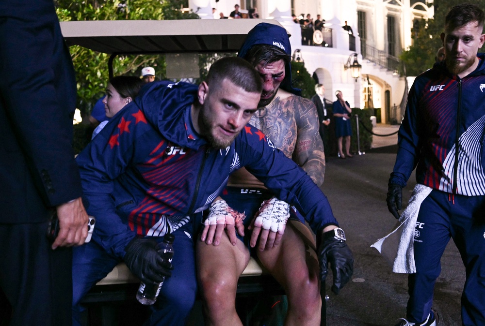 Ilia Topuria (right) is taken away from the White House in a wheelchair, escorted by his brother Aleksandre (AFP/Getty)