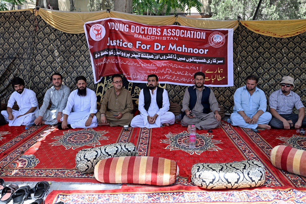Medical practitioners stage a protest to express solidarity with acid attack victim Dr Mahnoor Nasir in Quetta on 9 June 2026 (AFP/Getty)