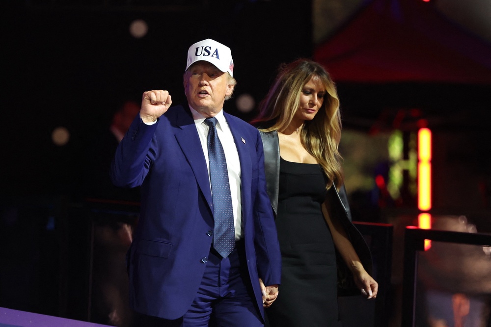 Donald Trump walks with First Lady Melania back inside the White House at the conclusion of UFC Freedom 250 (Reuters)