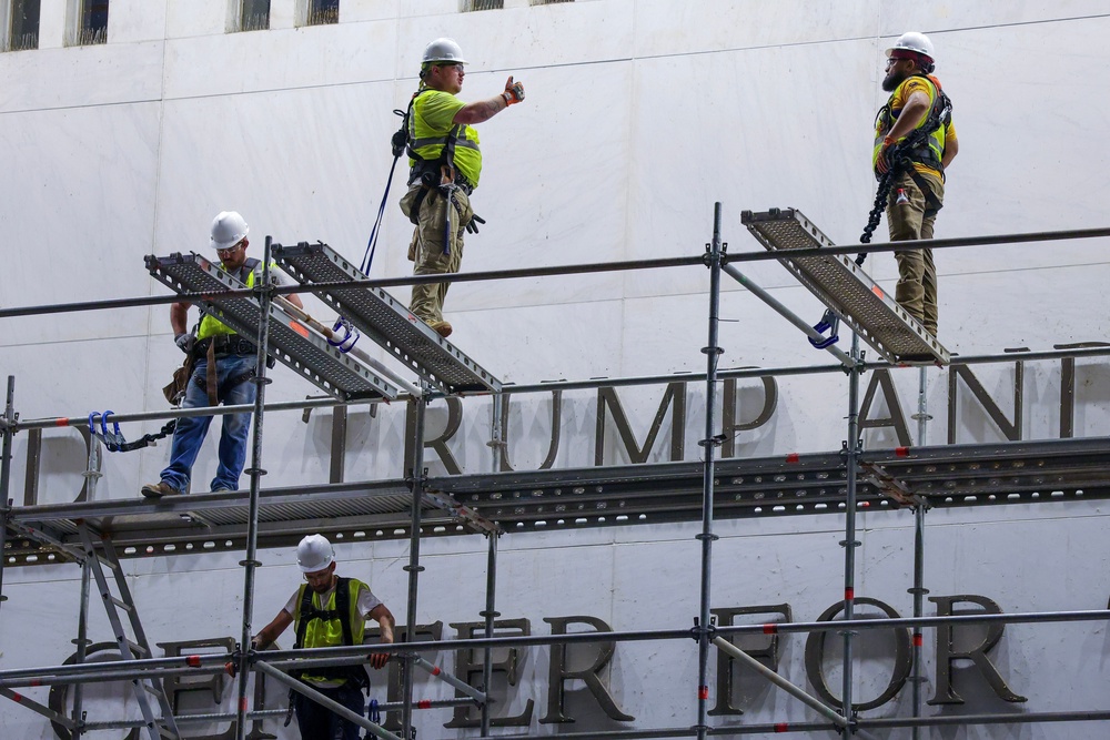Construction workers constructed scaffolding outside the Kennedy Center on June 12, hours before deadline to remove Trump’s name from the building (Getty)