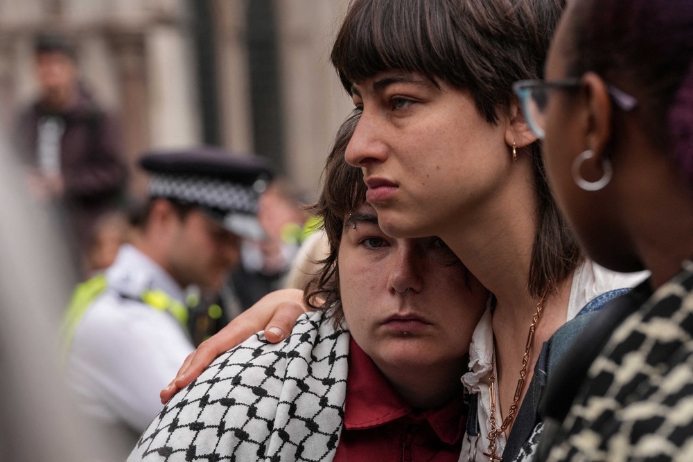 People react as they listen to the court proceedings outside the Royal Courts of Justice (AFP/Getty)