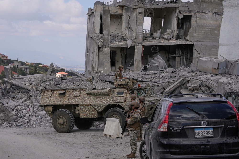 Lebanese soldiers are deployed in the village of Beer al-Salassel, south Lebanon, after people start to return to their villages, on 15 June (AP)