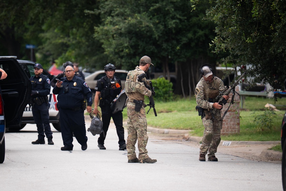 An officer at the scene described the alleged incident as “pretty serious”, with a weapon brandished by a suspect (James Manning/PA)