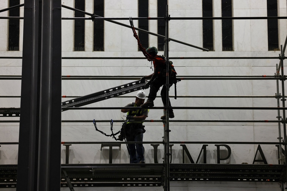 Workers set up scaffolding before removing President Donald Trump’s name from the Kennedy Center last week (Reuters)