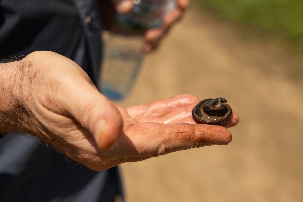 Martyn Fryer, an independent researcher, holds an artifact discovered at the usually submerged station (AP)