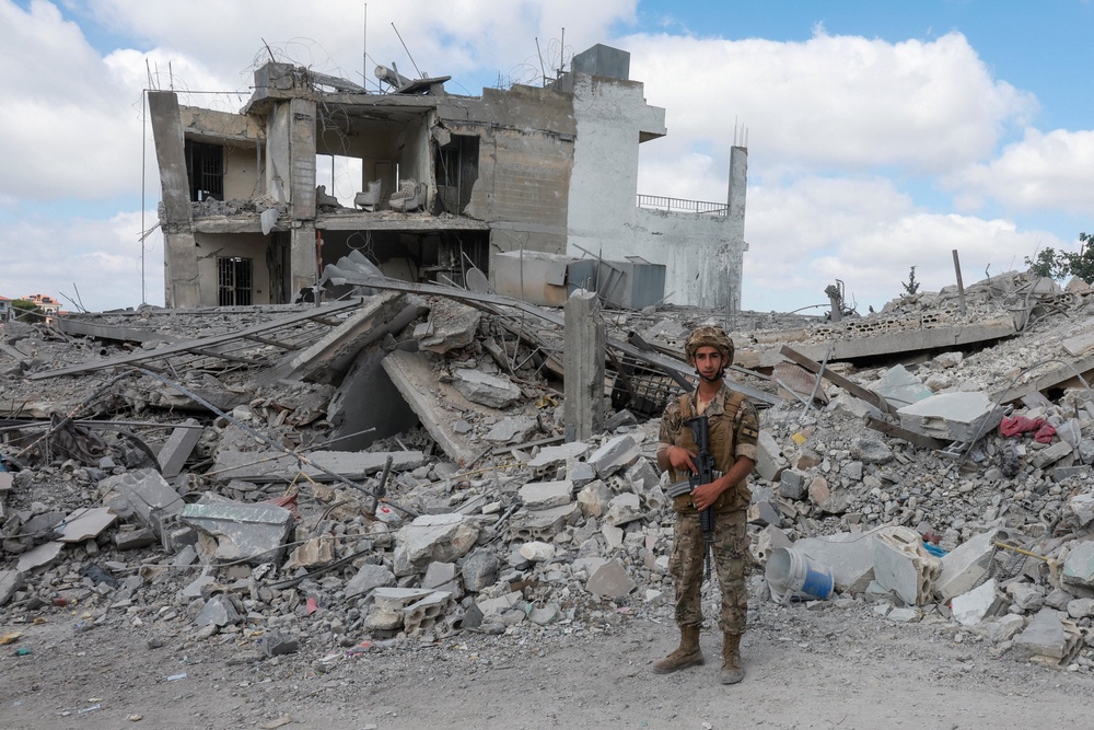 A member of the Lebanese army stands guard near the rubble of destroyed buildings, as people make their way back to their homes, following a peace deal between the United States and Iran, in Bir Al-Salasil, Tyre district, (Reuters)