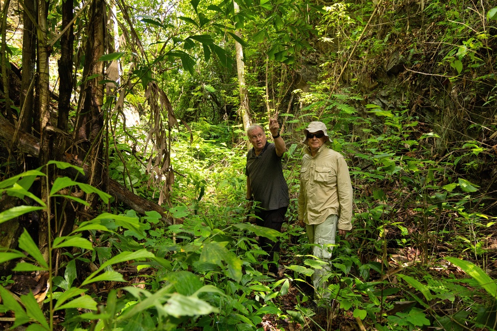 Researchers Andrew Snow, left, and Martyn Fryer trek into a section of the infamous Second World War ‘Death Railway’, leading to Nithe Station (AP)